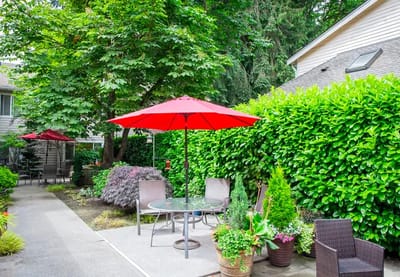 Courtyard with a table and red umbrellas