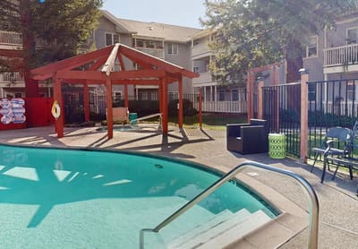Outdoor pool area with shaded seating