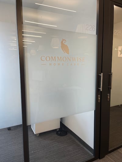 Commonwise Home Care logo on a frosted glass door
