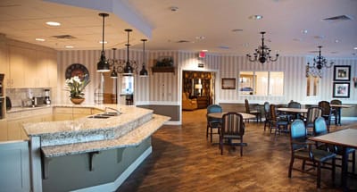 Interior view of a dining area with seating and kitchen space