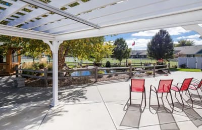 Outdoor patio with seating overlooking a garden.