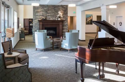 Bright common area with seating and a piano