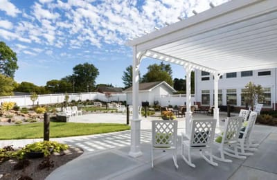 Outdoor seating area with rocking chairs and scenic view