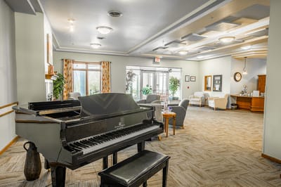 A bright common area with a grand piano