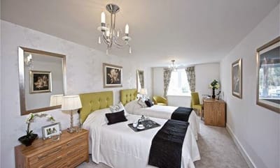 Brightly lit twin bedroom in a senior living facility