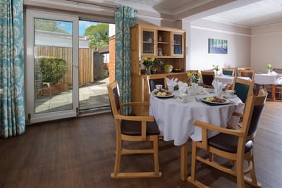 Dining area with tables set for meals and outdoor view