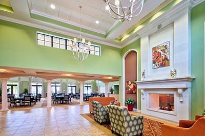 Bright common area with seating and fireplace