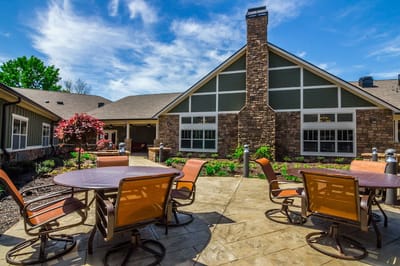 Outdoor patio area with seating and a building in the background