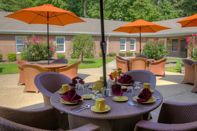 Outdoor dining setup with tables and umbrellas