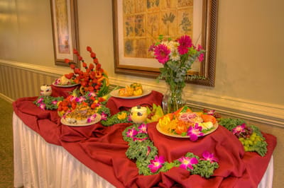 A beautifully arranged food display with fruit and flowers