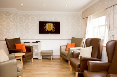Cozy lounge area with comfortable seating and a television