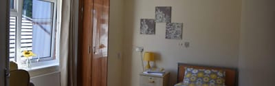 Private resident room with yellow decor and flowers