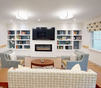Bright common area with comfortable seating and bookshelves