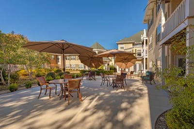 Outdoor patio area with umbrellas and seating