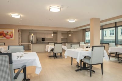 Bright dining room with tables set for meals