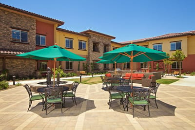 Outdoor area with green umbrellas and seating