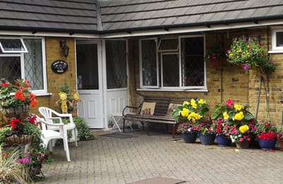 Colorful flowers and bench outside the facility entrance