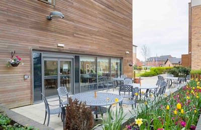 Outdoor seating area with tables near the Bistro