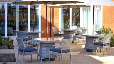 Outdoor seating area with tables and umbrellas