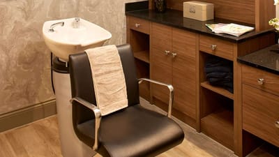 Interior view of a salon chair and cabinets