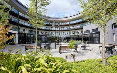 Outdoor courtyard area with seating and greenery