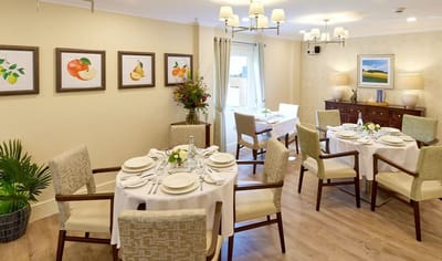 Bright dining room set for a meal with floral decorations