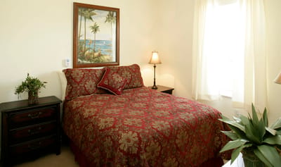 Cozy bedroom with floral bedding and a painting