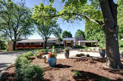 Exterior view of Hillside Terrace Senior Living surrounded by greenery