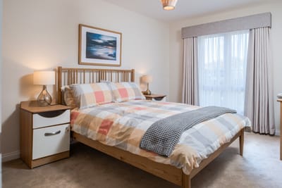 Cozy bedroom with a double bed and natural light