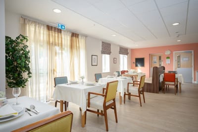 Bright dining area with tables set for meals