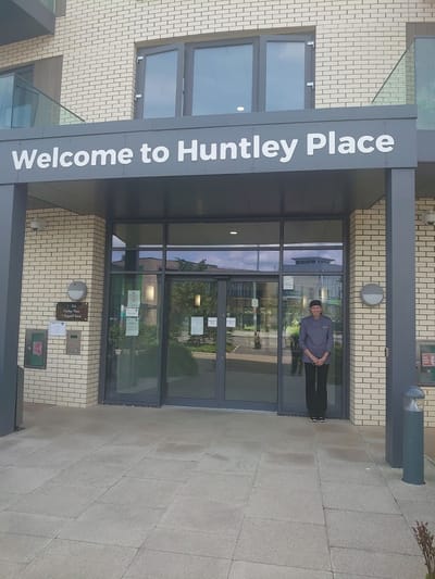 Front entrance of Huntley Place with staff member