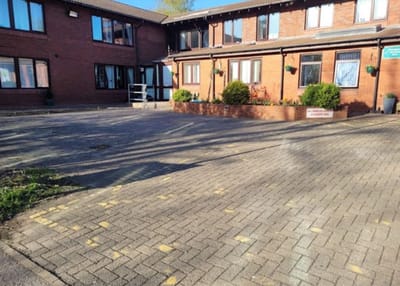 Exterior view of Hurstway Care Home's entrance and parking area