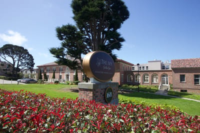 Facility signage in front of the building with landscaping