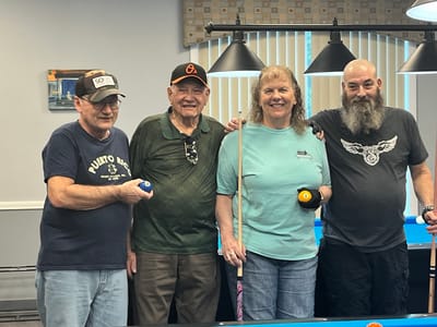 Residents and staff enjoying a game of billiards