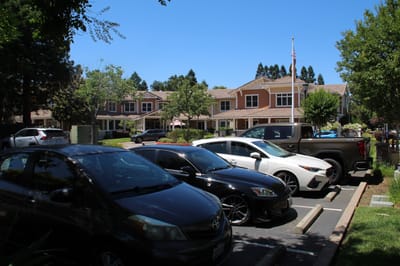 View of a nursing home facility with parked cars