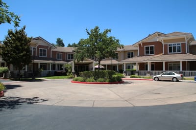 Building exterior with landscaped area and parking