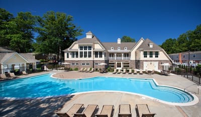 Aerial view of a pool area with a large building