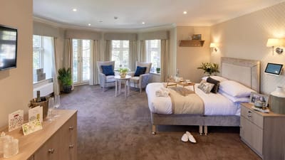A well-appointed resident room with natural light