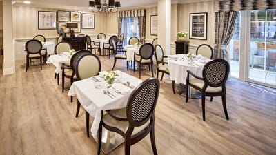 Elegant dining room with tables set for meals