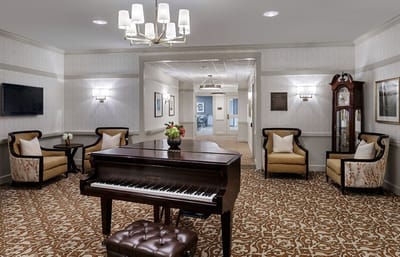 Common area with a piano and seating