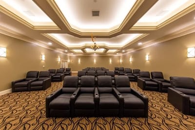 Cozy movie theater with reclining seats and ambient lighting