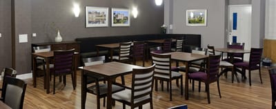 Dining room with tables and chairs in an indoor setting