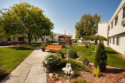 Well-maintained garden area with seating and residents.