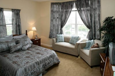 Cozy resident room with bed and seating area