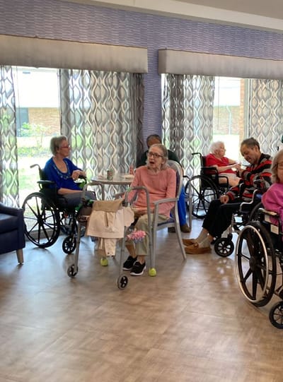 Residents in a common area with natural light