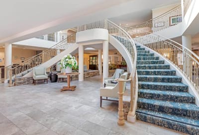 Elegant interior lobby with open staircase and seating