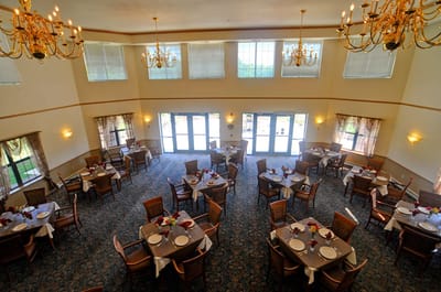 Dining room set for a meal with tables and chairs