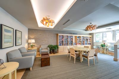 Bright common area with seating and bookshelves