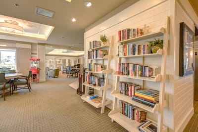 Bright common area with bookshelves and seating.