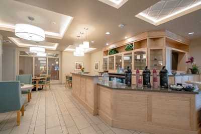 Bright and inviting common area with seating and refreshments